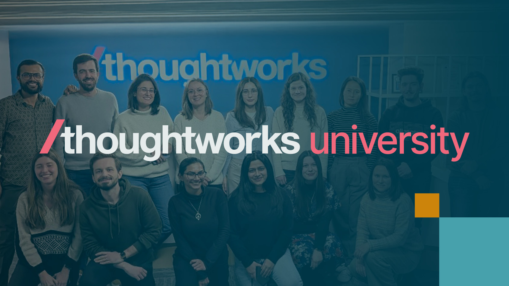 Group of Thoughtworkers in front of a blue wall featuring the Thoughtworks University logo in bold white text. Group of Thoughtworkers in front of a blue wall featuring the Thoughtworks University logo in bold white text.